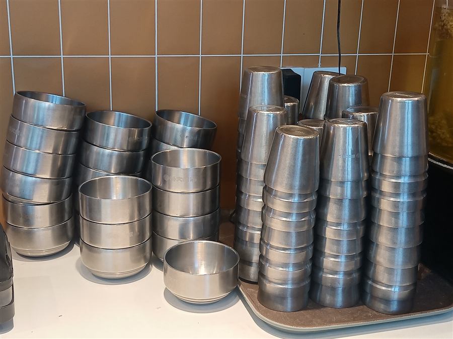 Stacks of stainless steel bowls and tumblers