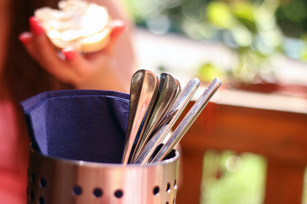Perforated stainless steel cutlery holder with spoons